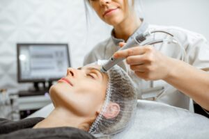 Woman making vacuum hydro peeling at the beauty salon