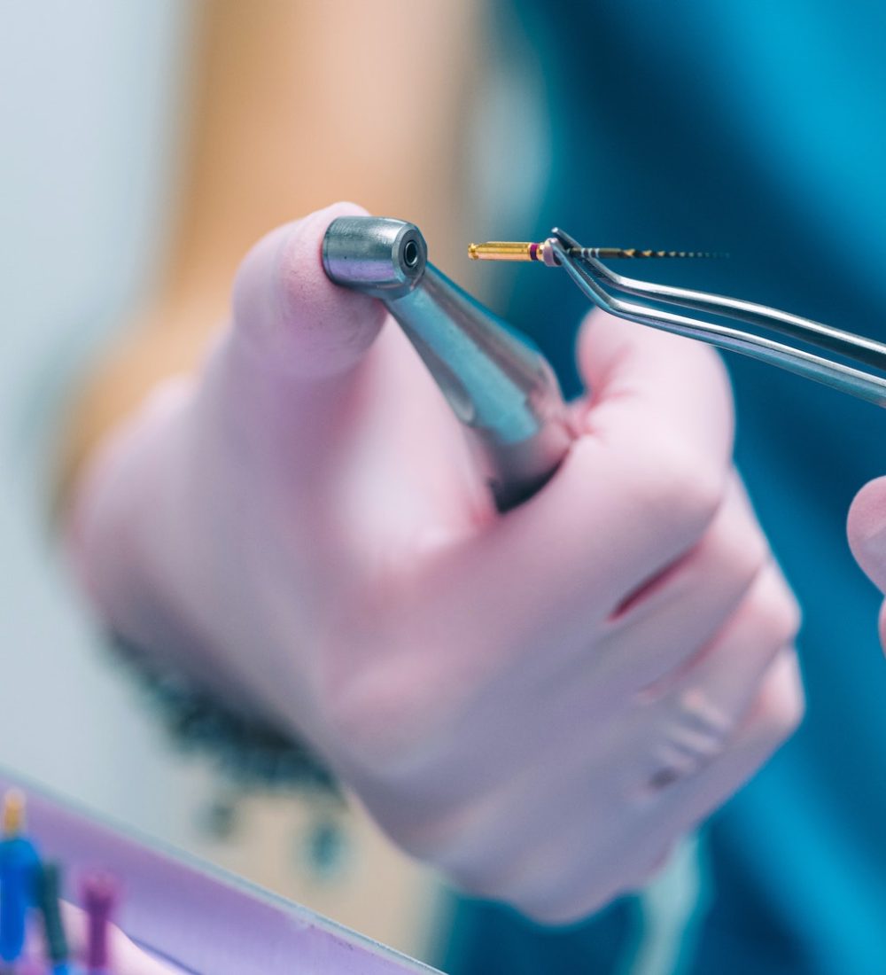 An Endodontist Holding Barbed Broach, Root Canal Treatment in Dental Clinic.